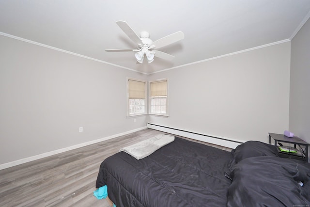 bedroom with wood finished floors, a baseboard radiator, ornamental molding, ceiling fan, and baseboards