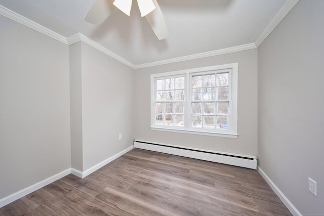 spare room with wood finished floors, a baseboard radiator, ceiling fan, baseboards, and crown molding
