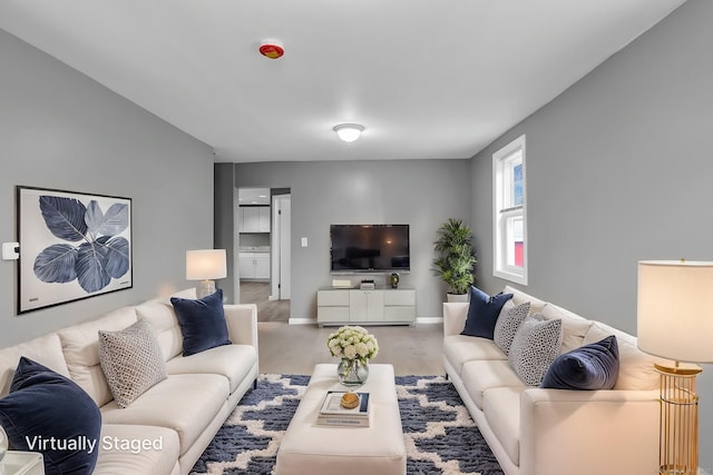 living area featuring baseboards