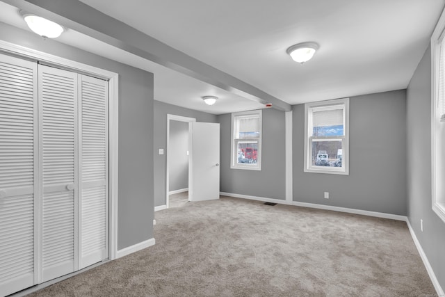 interior space with baseboards and carpet floors