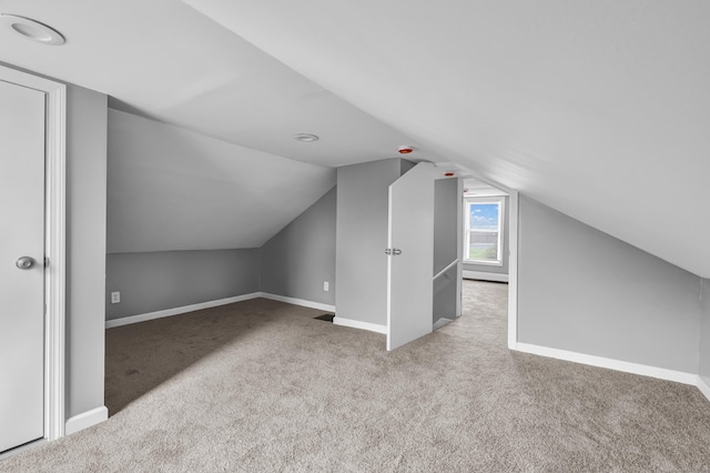 bonus room featuring baseboards, carpet, and vaulted ceiling