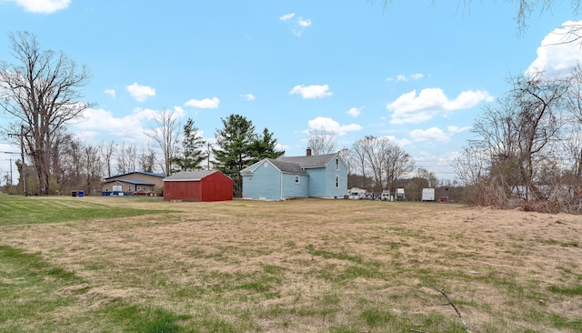 view of yard featuring an outbuilding and a shed
