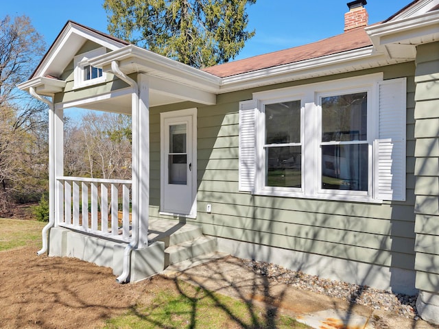 34 Power House Rd, Montville, CT 06382 - doorway to property with a chimney and covered porch