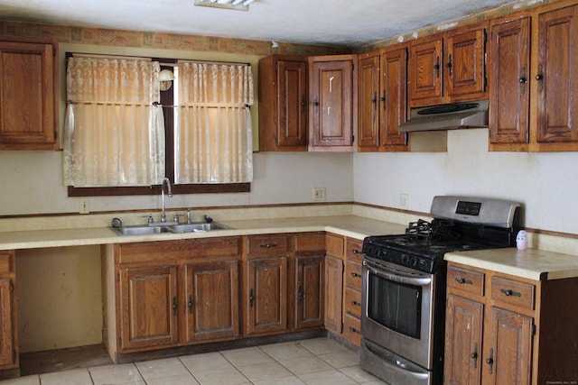 15 Wall St, Middletown, CT 06457 - kitchen featuring stainless steel range with gas cooktop, brown cabinetry, under cabinet range hood, and a sink