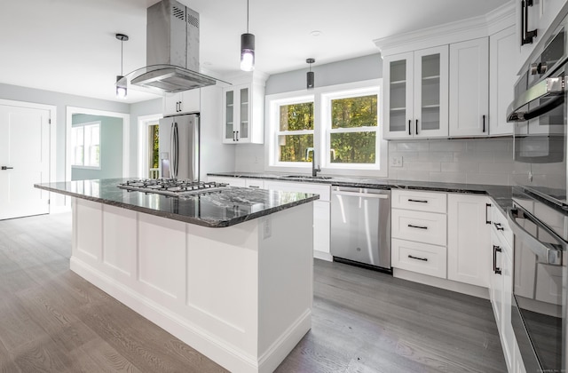 43 Moose Hill Rd, Trumbull, CT 06611 - kitchen featuring appliances with stainless steel finishes, island exhaust hood, a sink, and wood finished floors