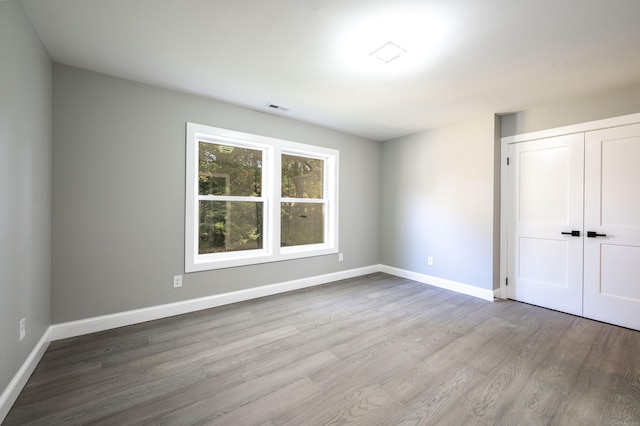 43 Moose Hill Rd, Trumbull, CT 06611 - unfurnished bedroom with wood finished floors, baseboards, and a closet