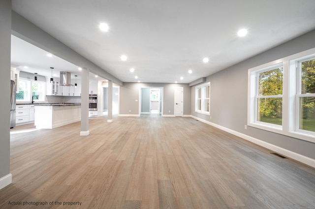 43 Moose Hill Rd, Trumbull, CT 06611 - unfurnished living room featuring light wood-style floors, recessed lighting, baseboards, and healthy amount of natural light