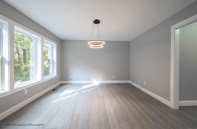 43 Moose Hill Rd, Trumbull, CT 06611 - spare room featuring wood finished floors, baseboards, and a chandelier