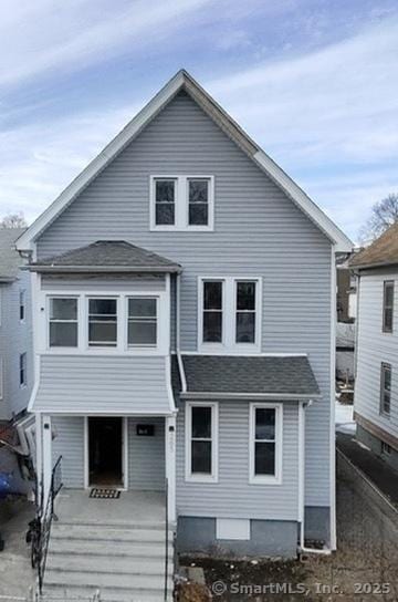 view of front of house with roof with shingles and a porch