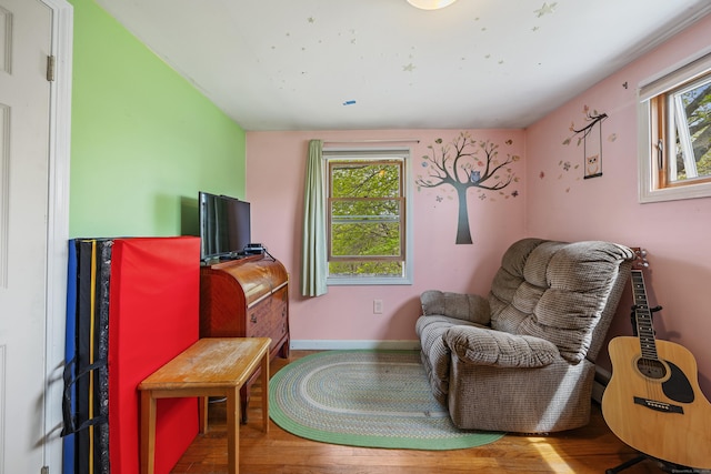 living area featuring wood finished floors and baseboards