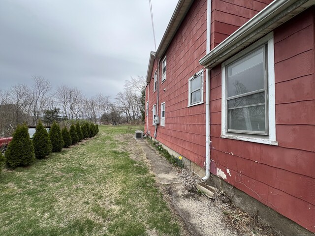 21-23 Elm St, Derby, CT 06418 - view of home's exterior featuring central AC unit and a lawn