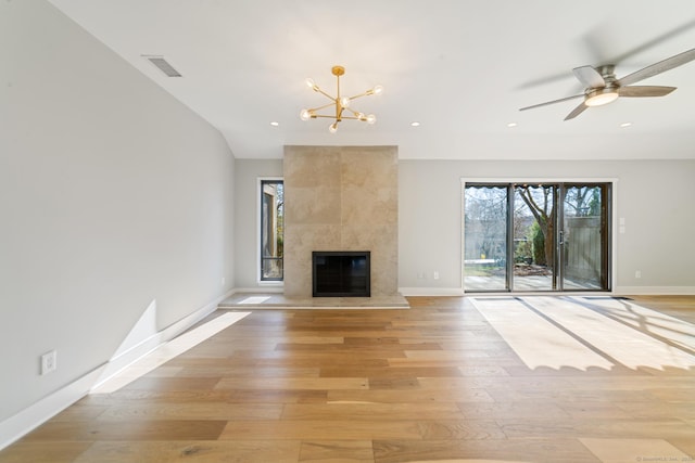 unfurnished living room featuring recessed lighting, a wealth of natural light, light wood-style floors, and baseboards