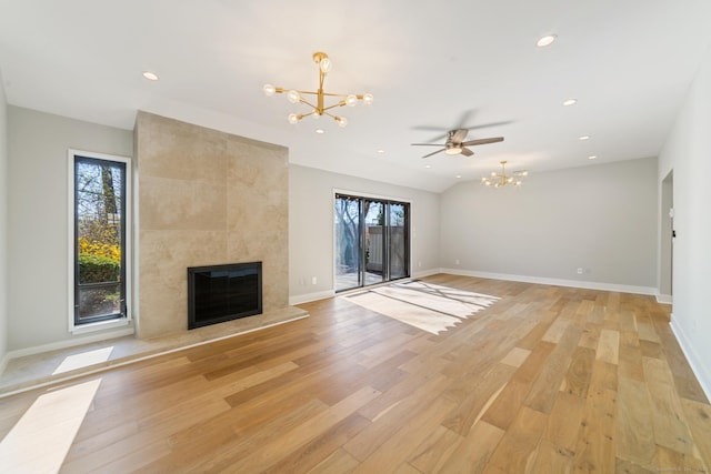 unfurnished living room with a fireplace, light wood-style flooring, a wealth of natural light, and recessed lighting