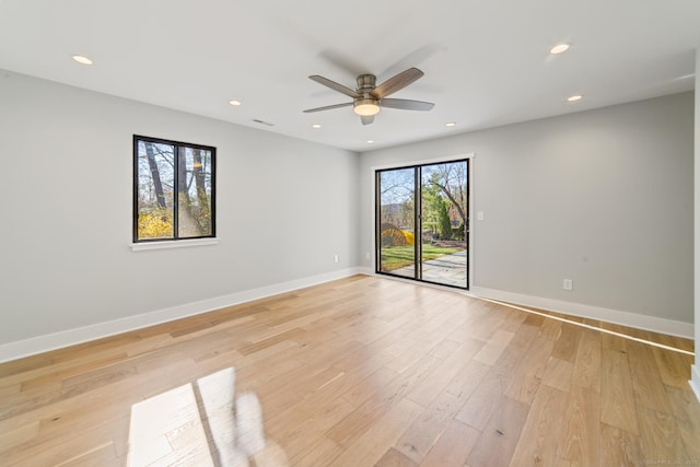 empty room featuring a ceiling fan, light wood finished floors, baseboards, visible vents, and recessed lighting