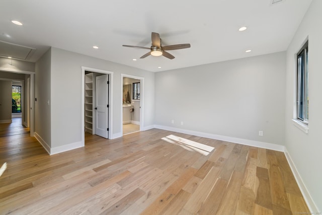 spare room featuring recessed lighting, light wood finished floors, a ceiling fan, baseboards, and attic access