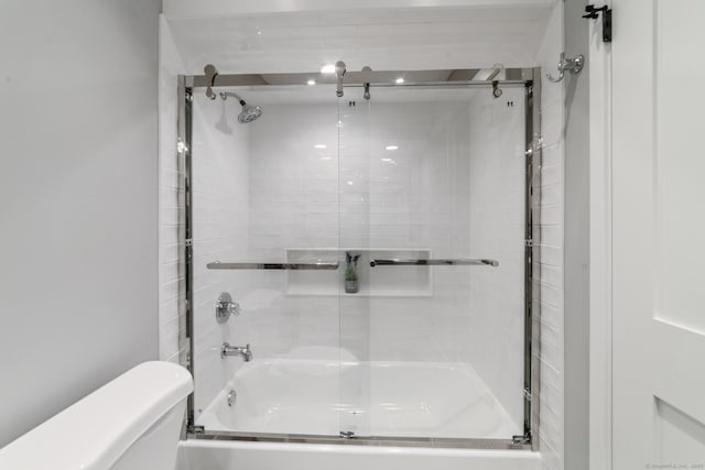 bathroom with toilet and enclosed tub / shower combo