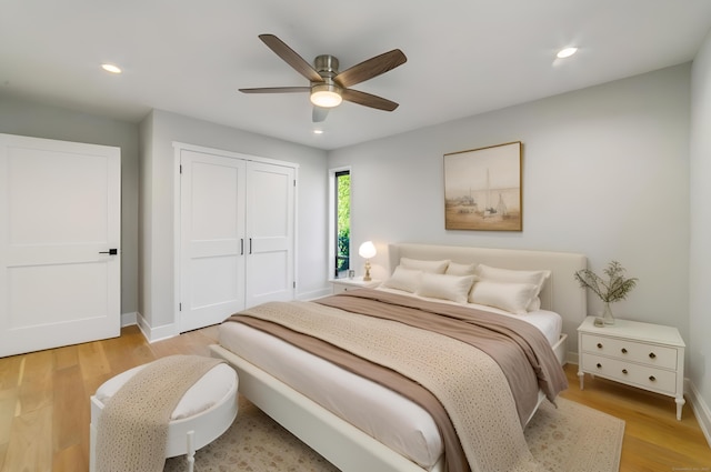 bedroom featuring a ceiling fan, a closet, light wood finished floors, baseboards, and recessed lighting