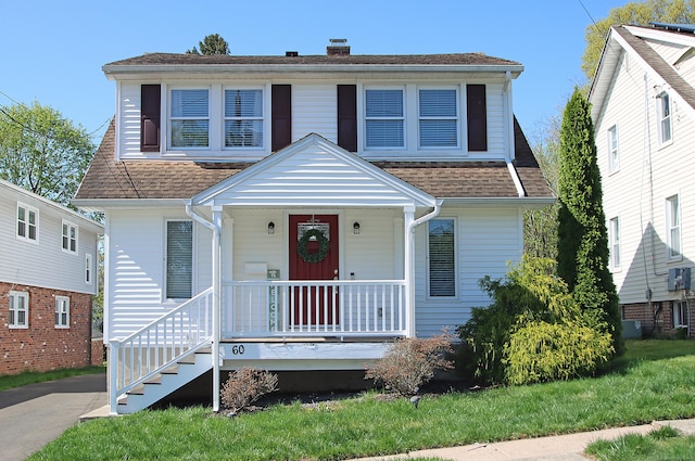 bungalow featuring covered porch and a chimney