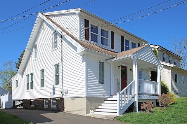 view of front of home with covered porch and a shingled roof