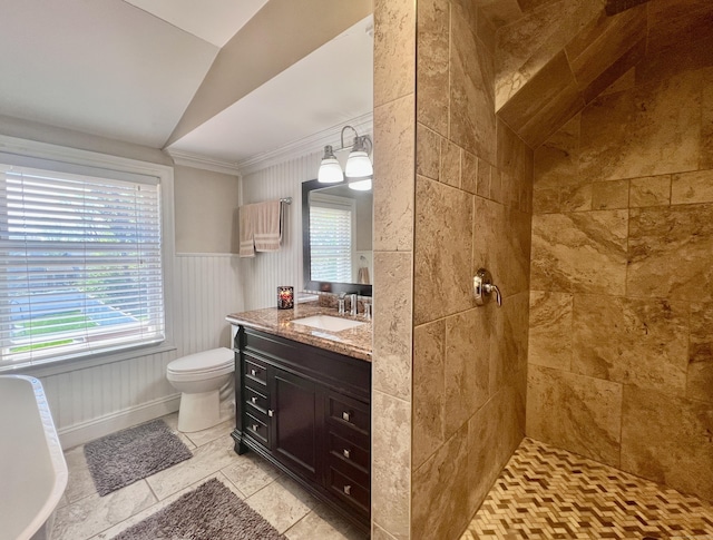 bathroom featuring toilet, plenty of natural light, tiled shower, and lofted ceiling