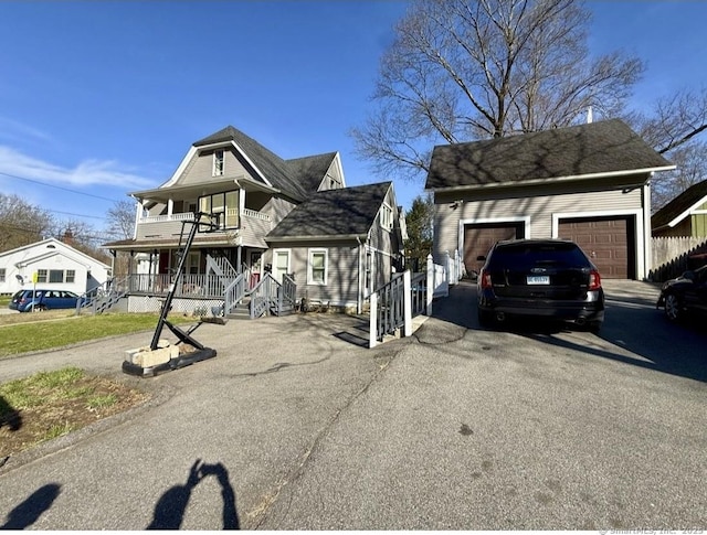 view of front of home with a garage, a porch, and a balcony