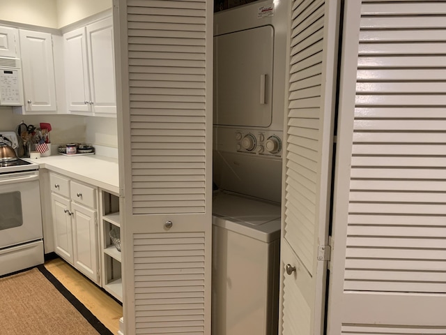 laundry room featuring stacked washer and clothes dryer and laundry area