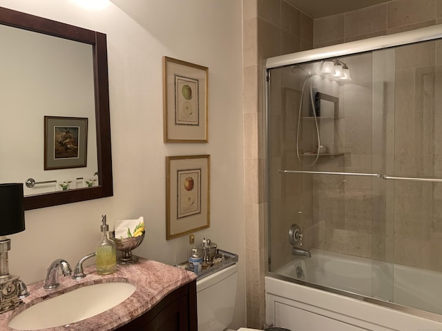 bathroom featuring shower / bath combination with glass door, toilet, and vanity