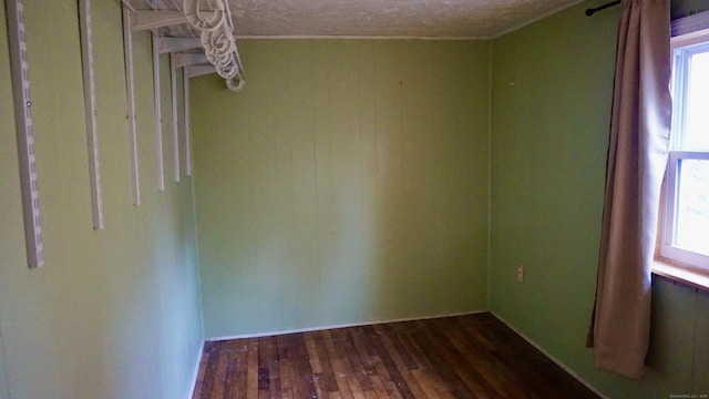 empty room featuring dark wood finished floors and a textured ceiling