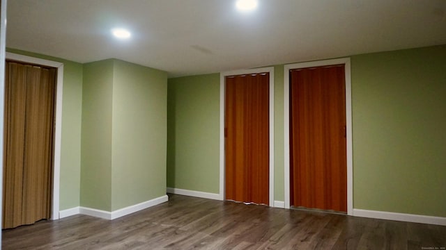 unfurnished room with baseboards, wood finished floors, and recessed lighting