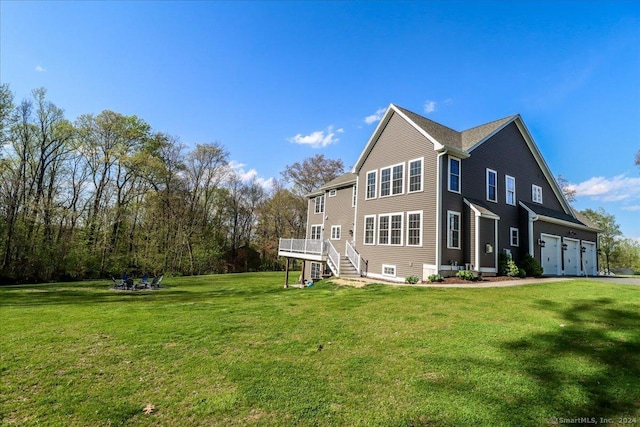 back of house featuring stairs, a yard, and a deck