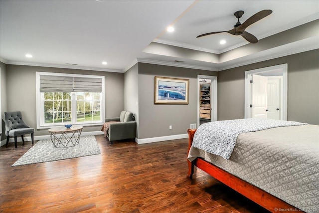 bedroom with recessed lighting, wood finished floors, crown molding, and baseboards