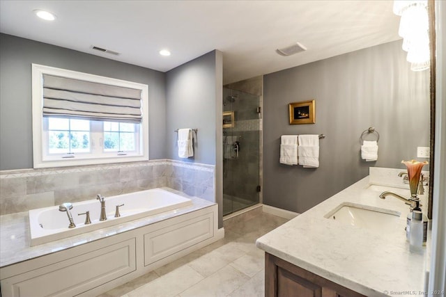 full bathroom featuring a bath, tile patterned floors, a sink, and a shower stall