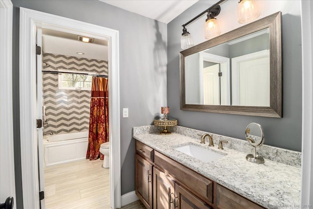 full bathroom featuring baseboards, toilet, vanity, and shower / bathtub combination with curtain