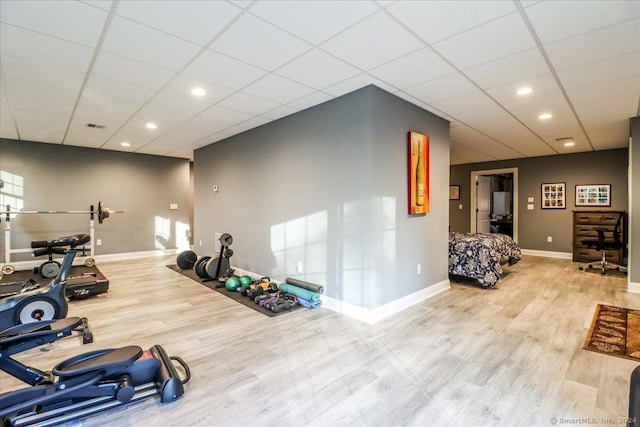 workout area featuring recessed lighting, wood finished floors, visible vents, baseboards, and a paneled ceiling