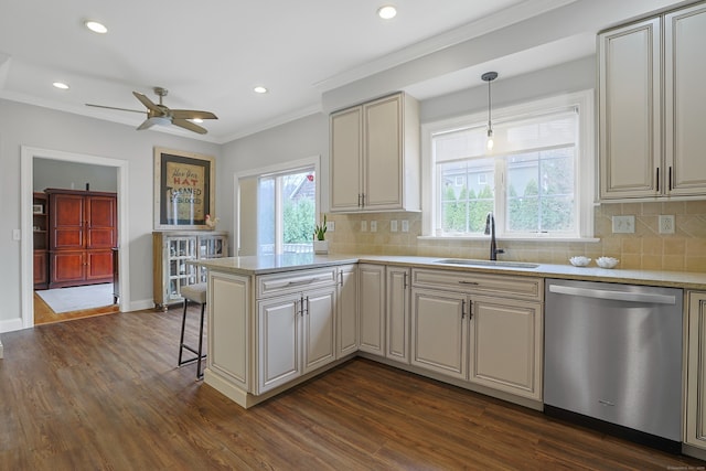 kitchen featuring a ceiling fan, dishwasher, dark wood-style flooring, a sink, and a peninsula