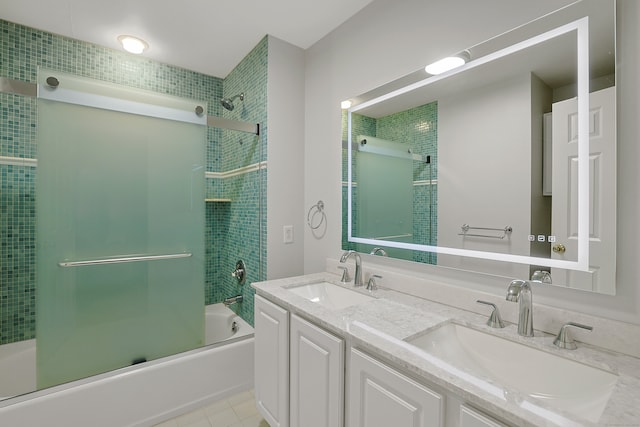 full bathroom featuring  shower combination, tile patterned flooring, double vanity, and a sink