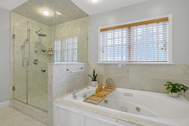 bathroom with a stall shower and a jetted tub