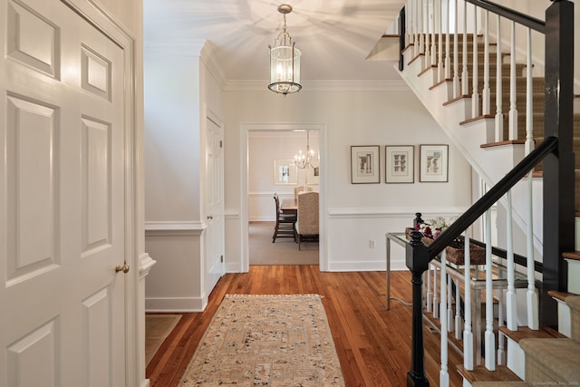 6 Wahackme Ln, New Canaan, CT 06840 - entrance foyer with a chandelier, hardwood / wood-style floors, stairs, baseboards, and ornamental molding