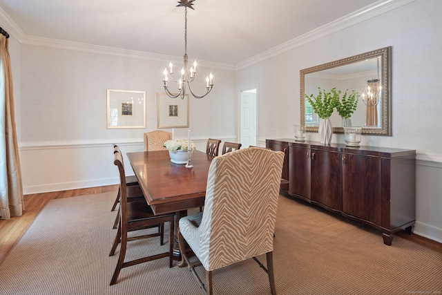 6 Wahackme Ln, New Canaan, CT 06840 - dining space with baseboards, an inviting chandelier, ornamental molding, and light wood-style flooring