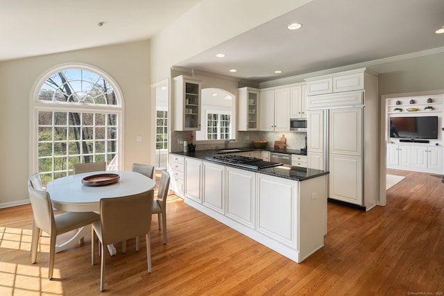 6 Wahackme Ln, New Canaan, CT 06840 - kitchen with appliances with stainless steel finishes, tasteful backsplash, a sink, light wood finished floors, and glass insert cabinets