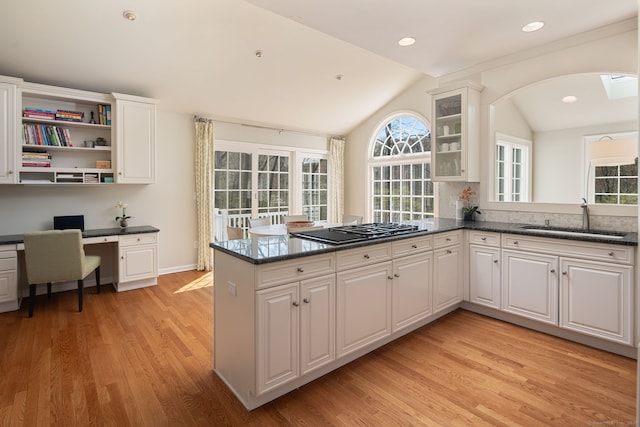 6 Wahackme Ln, New Canaan, CT 06840 - kitchen featuring a sink, black gas cooktop, a peninsula, white cabinetry, and vaulted ceiling