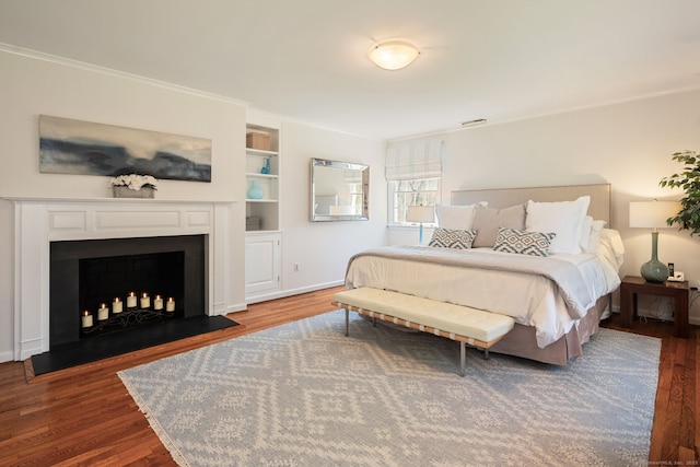 6 Wahackme Ln, New Canaan, CT 06840 - bedroom with crown molding, baseboards, a fireplace with flush hearth, and wood finished floors