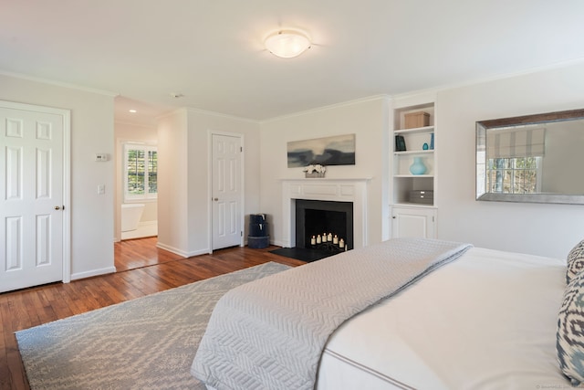 6 Wahackme Ln, New Canaan, CT 06840 - bedroom with wood-type flooring, ornamental molding, a fireplace with flush hearth, and baseboards