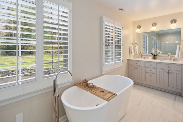 6 Wahackme Ln, New Canaan, CT 06840 - bathroom featuring a sink, a shower with shower door, double vanity, a freestanding tub, and visible vents