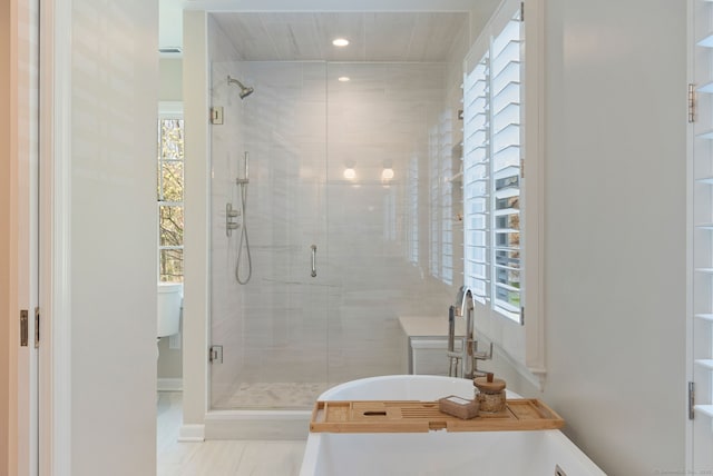 6 Wahackme Ln, New Canaan, CT 06840 - bathroom featuring recessed lighting, baseboards, a freestanding bath, and a stall shower