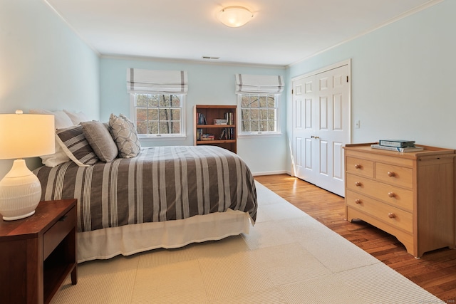 6 Wahackme Ln, New Canaan, CT 06840 - bedroom featuring crown molding, wood finished floors, visible vents, and a closet
