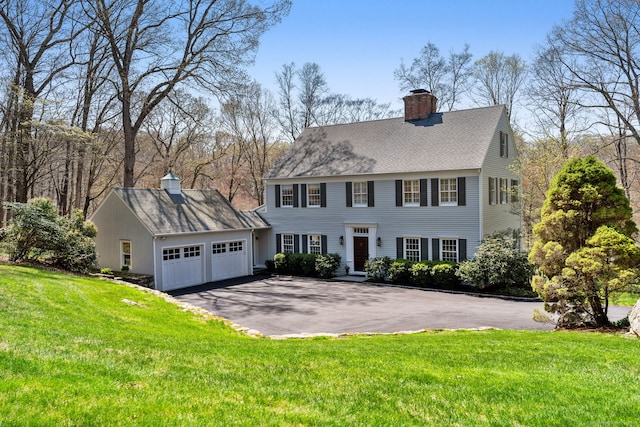 6 Wahackme Ln, New Canaan, CT 06840 - colonial-style house featuring a chimney, an attached garage, a front yard, and aphalt driveway