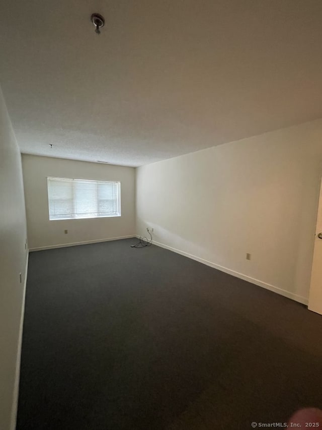 75 Washington Ave Unit 4207, Hamden, CT 06518 - empty room with dark colored carpet, baseboards, and a pendent fire sprinkler