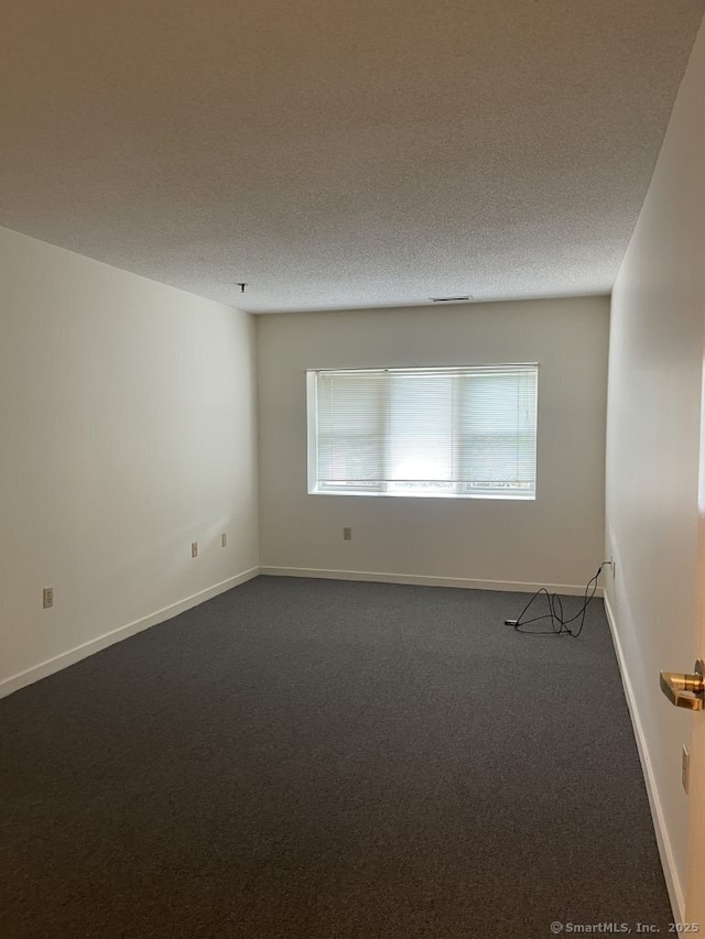 75 Washington Ave Unit 4207, Hamden, CT 06518 - spare room featuring dark colored carpet and baseboards