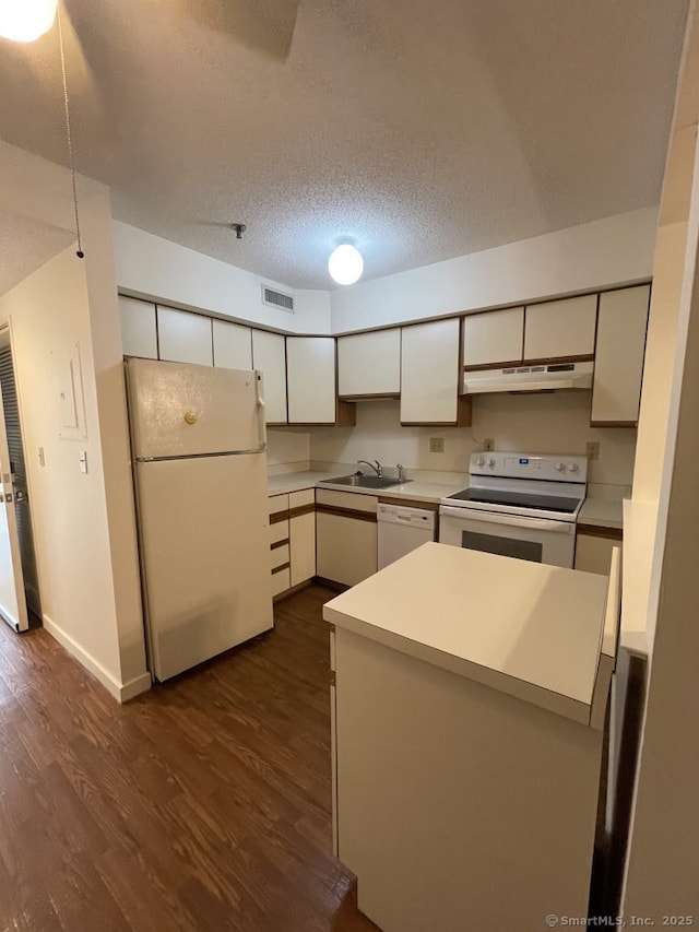 75 Washington Ave Unit 4207, Hamden, CT 06518 - kitchen featuring white appliances, under cabinet range hood, dark wood-type flooring, white cabinetry, and a heating unit